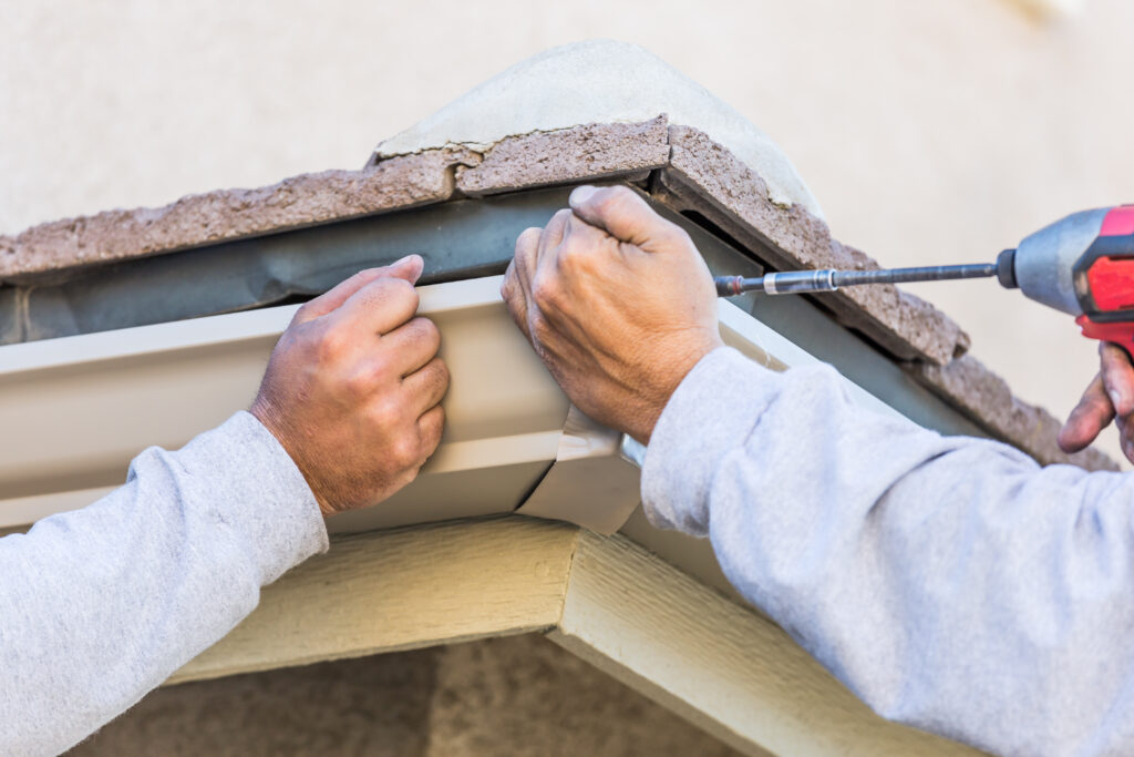 Kirby Smith - workers-attaching-aluminum-rain-gutter-to-fascia-o-2023-11-27-05-11-27-utc-scaled.jpg